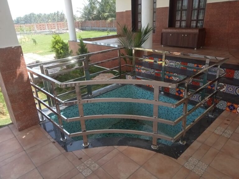 Curved stainless steel railing around a terrace water feature in Coimbatore