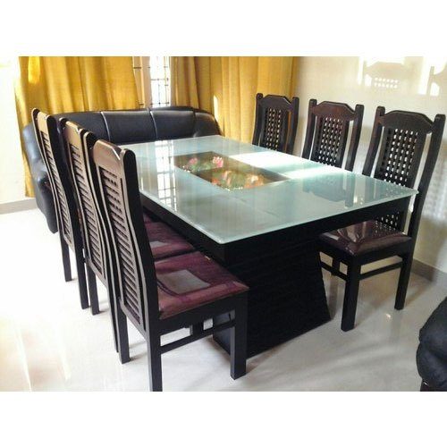 Customised wooden dining table with glass top and eight chairs in Coimbatore