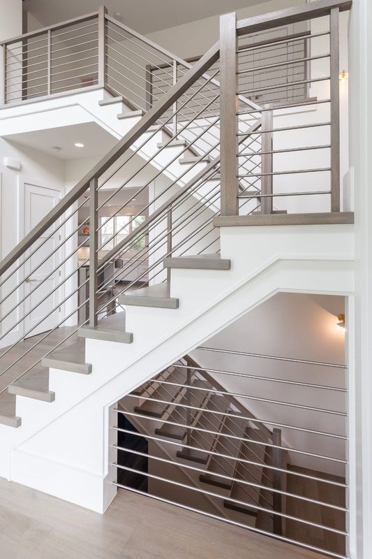 Indoor stainless steel staircase railing on a white timber stair in Coimbatore