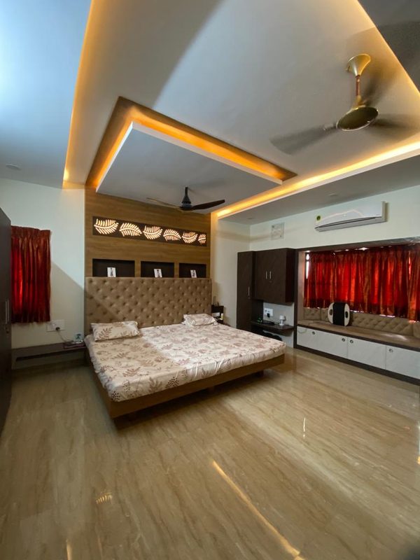 Luxury bedroom interior with false ceiling and cove lighting by residential decorators in Coimbatore
